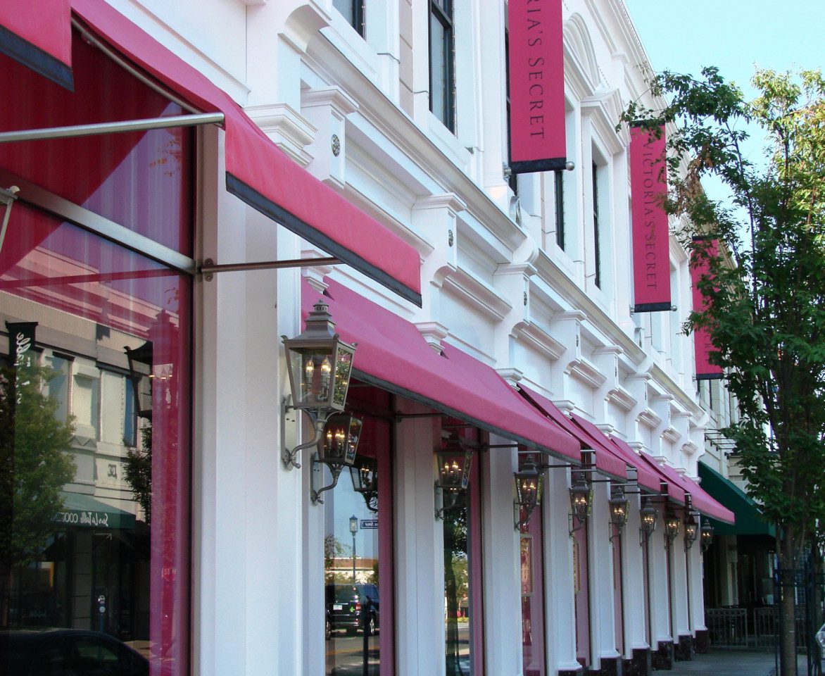 A building with pink awnings on the side of it.
